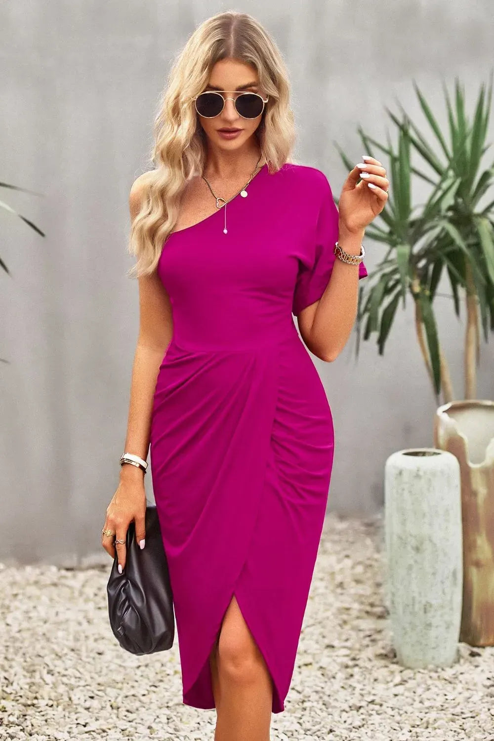 Woman wearing a vibrant pink dress with a blurred background
