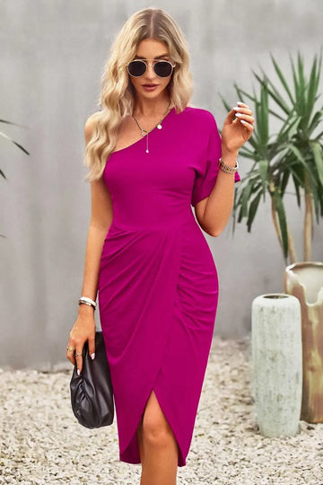 Woman wearing a vibrant pink dress with a blurred background